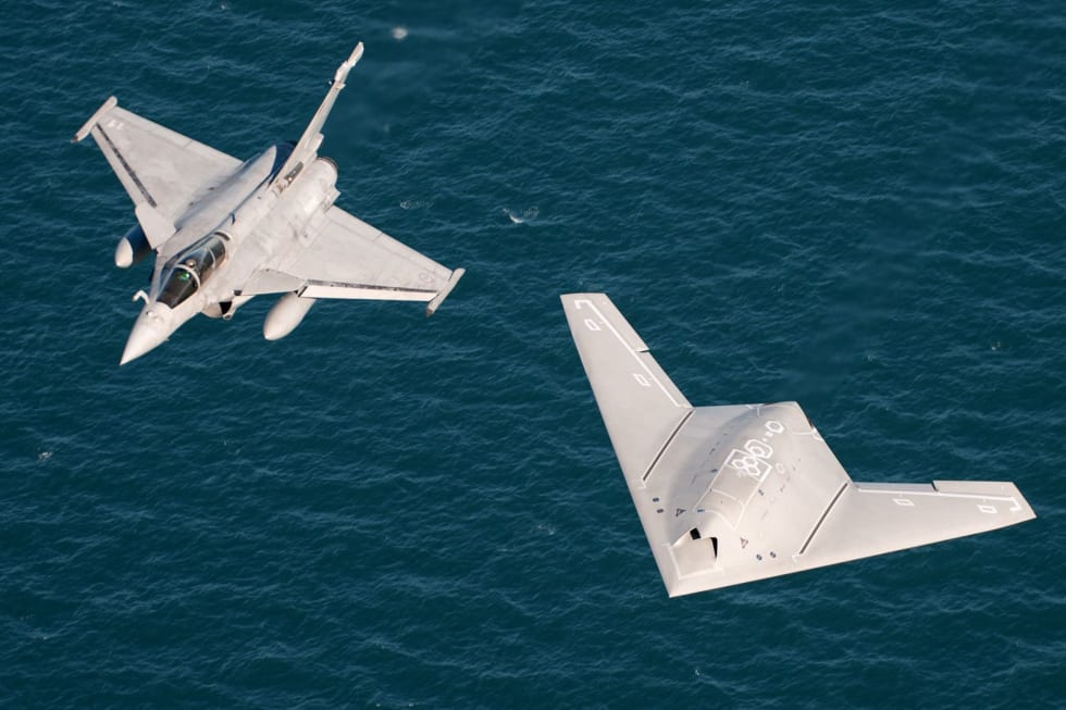 nEUROn and Rafale M in flight over the Charles de Gaulle aircraft carrier.