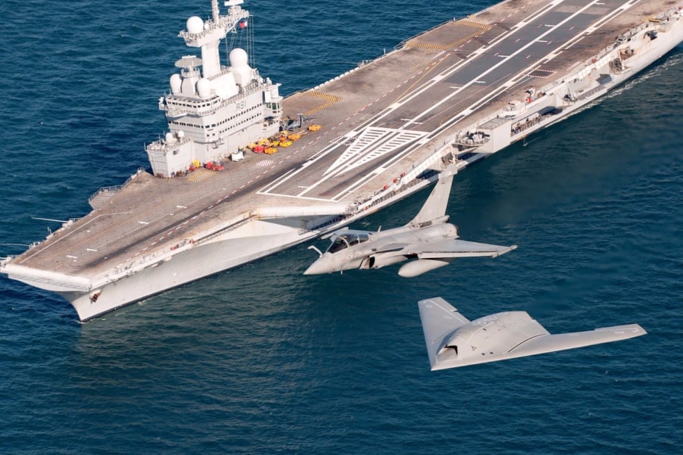 nEUROn and Rafale M in flight over the Charles de Gaulle aircraft carrier.